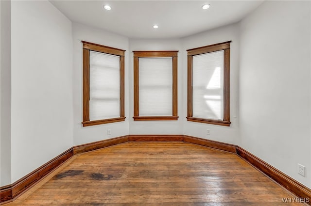 unfurnished room with hardwood / wood-style floors