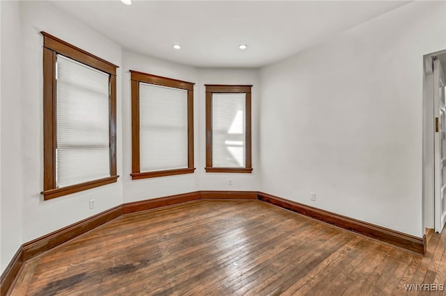 empty room with hardwood / wood-style flooring