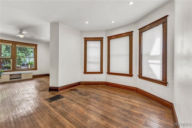 spare room featuring ceiling fan and dark hardwood / wood-style flooring