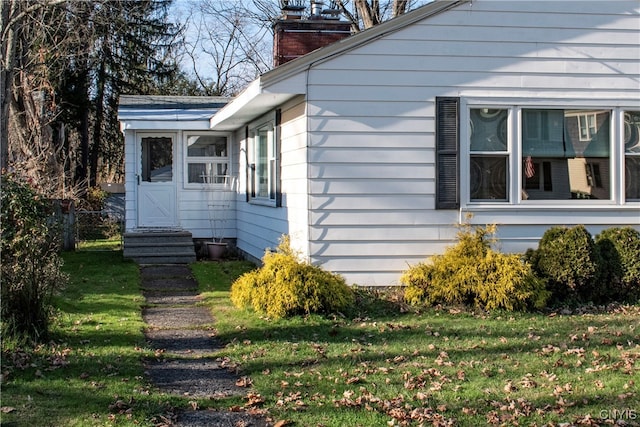 view of property exterior with a yard