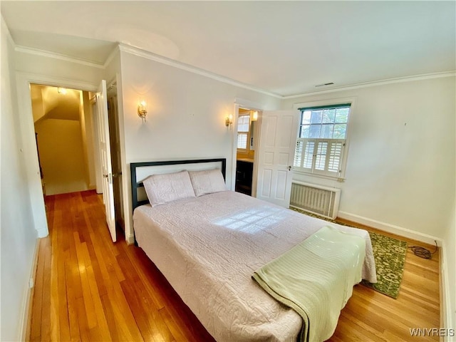 9 Mayfair Ln, Buffalo, NY 14201 - bedroom featuring radiator, crown molding, wood finished floors, and baseboards