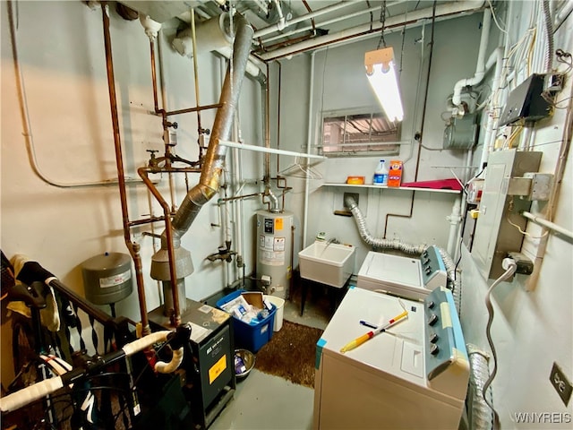 utility room with water heater, sink, and washer and dryer