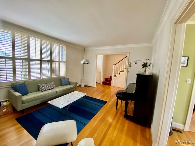 living room featuring hardwood / wood-style flooring and crown molding