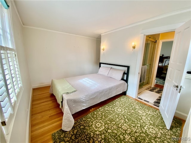 bedroom with hardwood / wood-style floors and crown molding