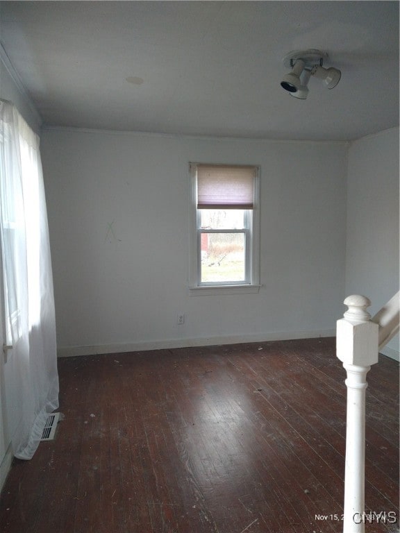 empty room with dark hardwood / wood-style flooring