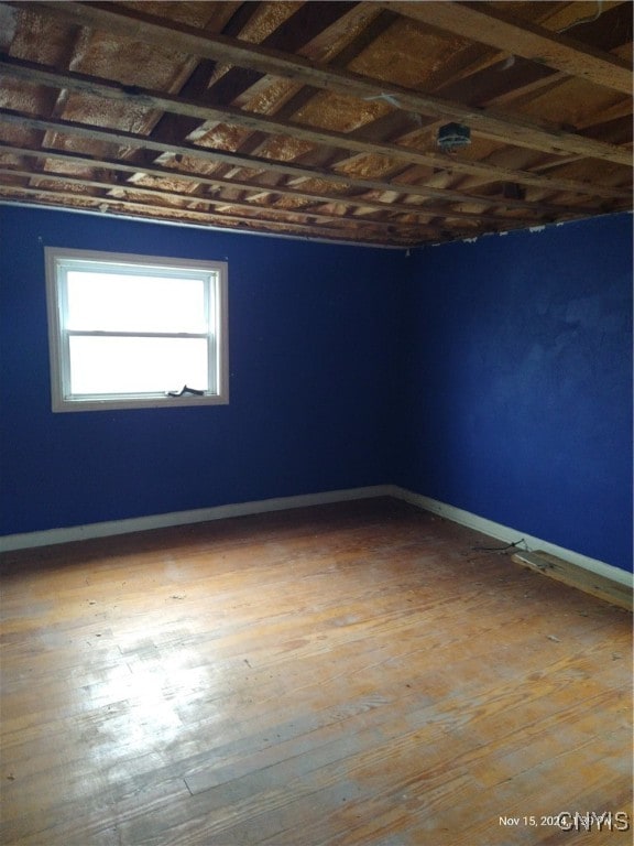 unfurnished room with hardwood / wood-style floors