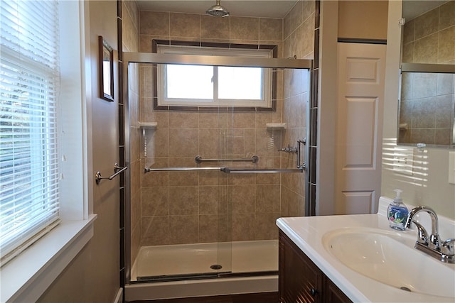 bathroom featuring vanity and an enclosed shower