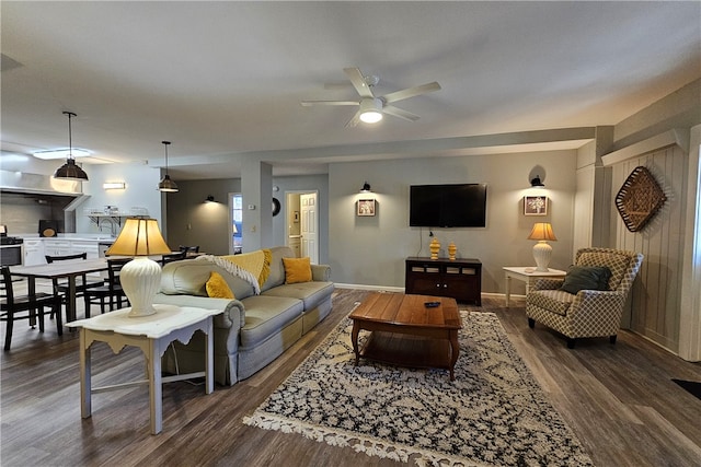 living room featuring ceiling fan and dark hardwood / wood-style floors