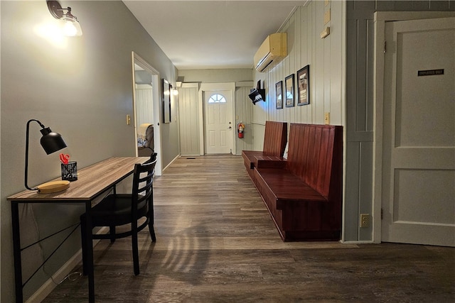 interior space with a wall unit AC and dark hardwood / wood-style flooring