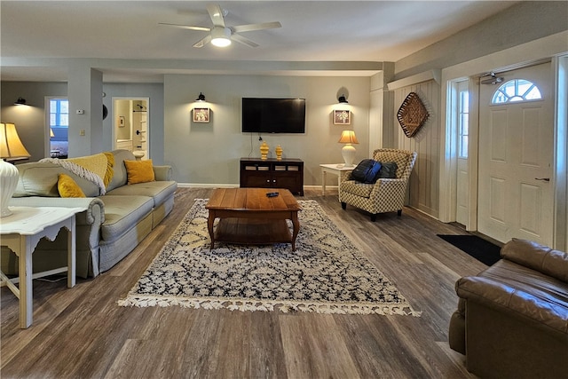 living room featuring a wealth of natural light, dark hardwood / wood-style flooring, and ceiling fan