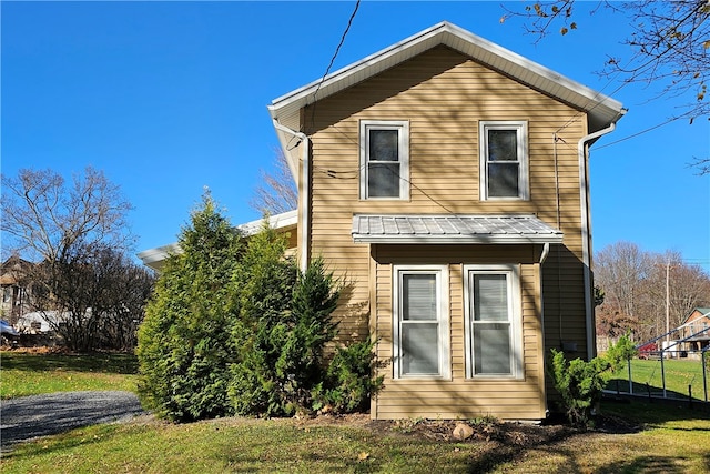 view of home's exterior with a lawn