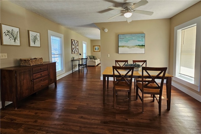 dining space featuring a textured ceiling, ceiling fan, a healthy amount of sunlight, and dark wood-type flooring