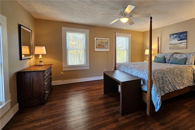 bedroom featuring a textured ceiling, dark hardwood / wood-style floors, and ceiling fan