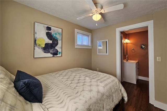 bedroom featuring a textured ceiling, ceiling fan, sink, connected bathroom, and dark hardwood / wood-style floors