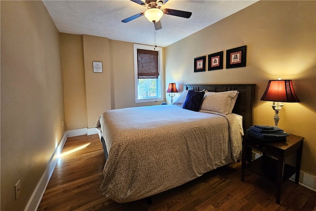 bedroom featuring ceiling fan, dark hardwood / wood-style flooring, and a textured ceiling