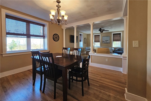 dining area with dark hardwood / wood-style flooring, ceiling fan with notable chandelier, and plenty of natural light