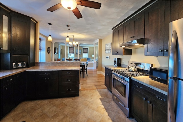 kitchen featuring kitchen peninsula, appliances with stainless steel finishes, light wood-type flooring, dark brown cabinetry, and pendant lighting