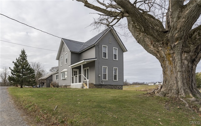 view of side of home with a lawn