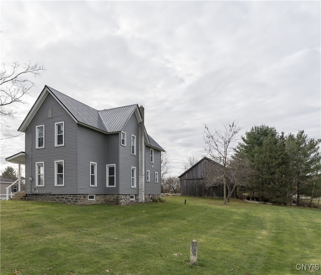 view of side of home featuring a yard