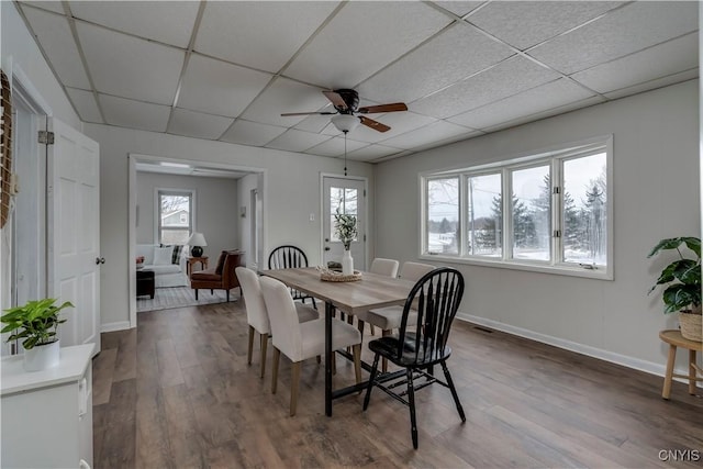 dining area with a paneled ceiling, ceiling fan, and hardwood / wood-style floors