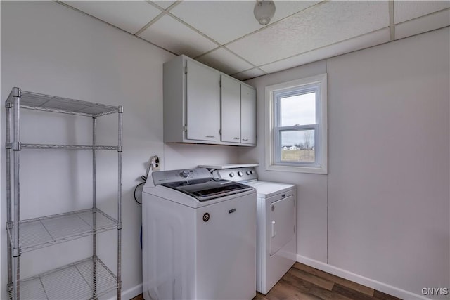 laundry room featuring wood-type flooring, cabinets, and independent washer and dryer