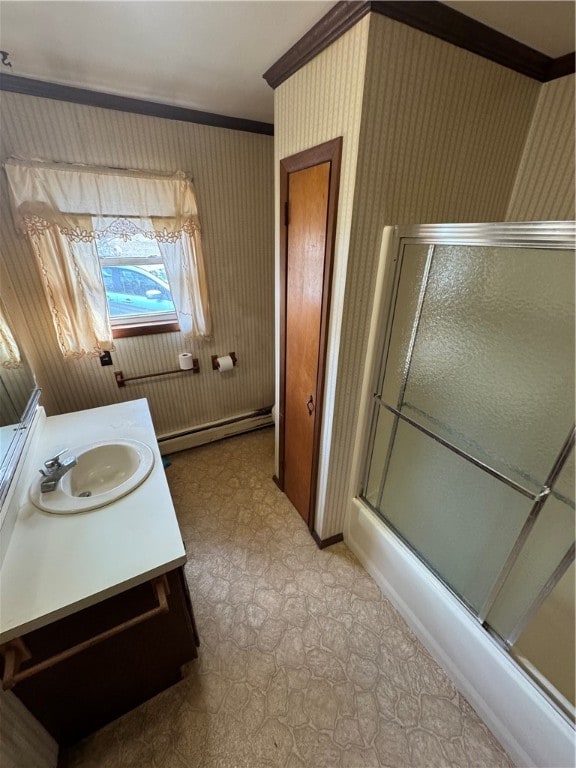 bathroom with crown molding, bath / shower combo with glass door, vanity, and a baseboard radiator