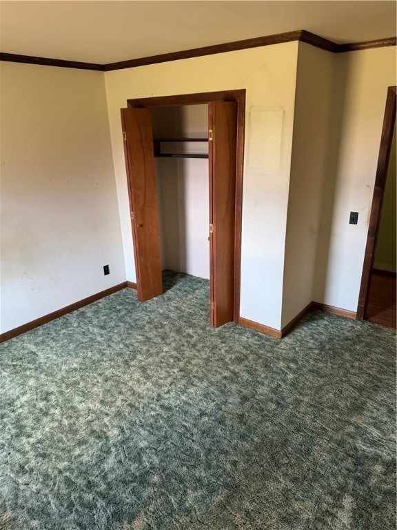 unfurnished bedroom with dark colored carpet, a closet, and ornamental molding