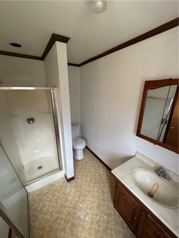 bathroom with an enclosed shower, vanity, toilet, and crown molding