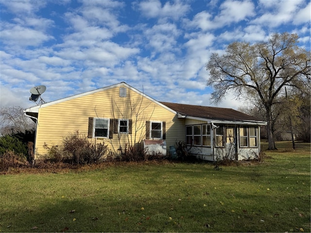 exterior space featuring a front yard and a sunroom