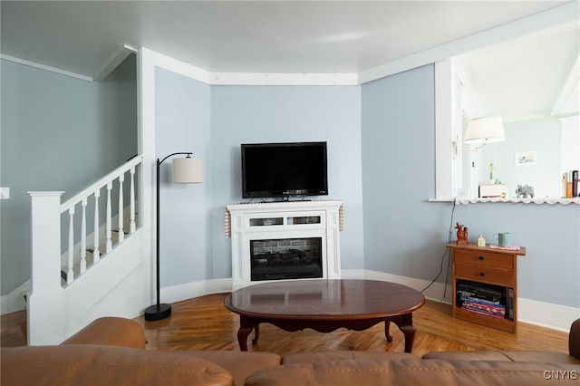 living room with hardwood / wood-style floors and crown molding