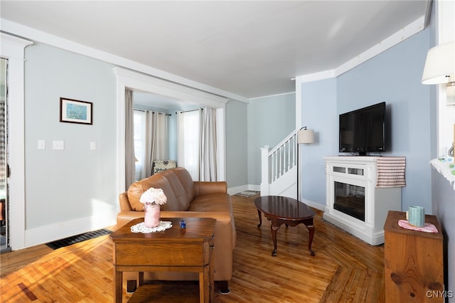 living room featuring a wealth of natural light and ornamental molding