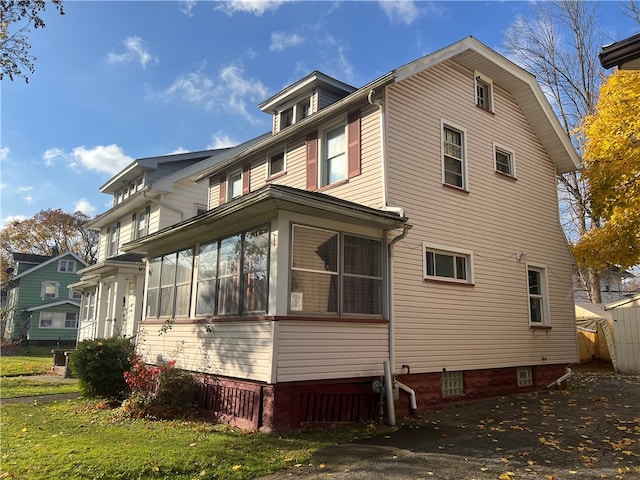 view of side of home with a sunroom