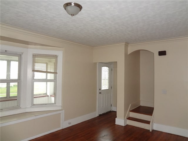 entrance foyer featuring dark hardwood / wood-style floors and crown molding