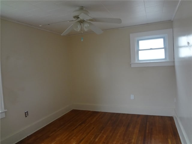 empty room with crown molding, ceiling fan, and dark hardwood / wood-style floors