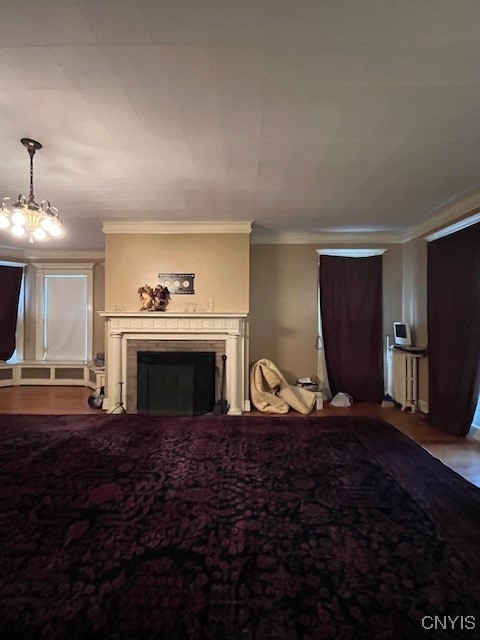 bedroom with radiator, a chandelier, and ornamental molding