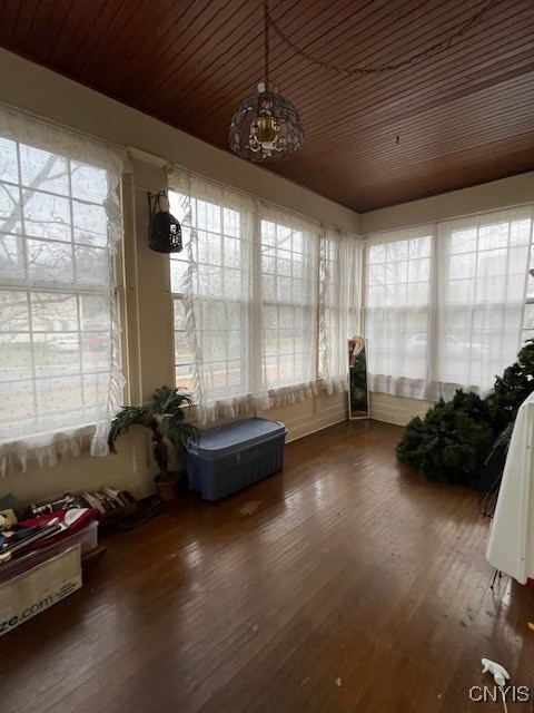 unfurnished sunroom featuring plenty of natural light and wooden ceiling