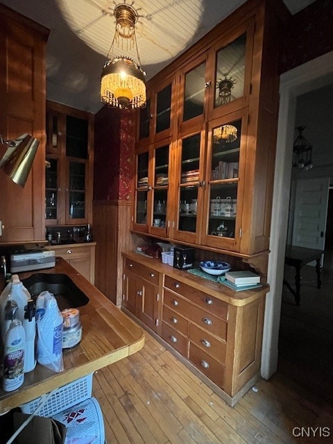 dining space featuring wooden walls and light wood-type flooring