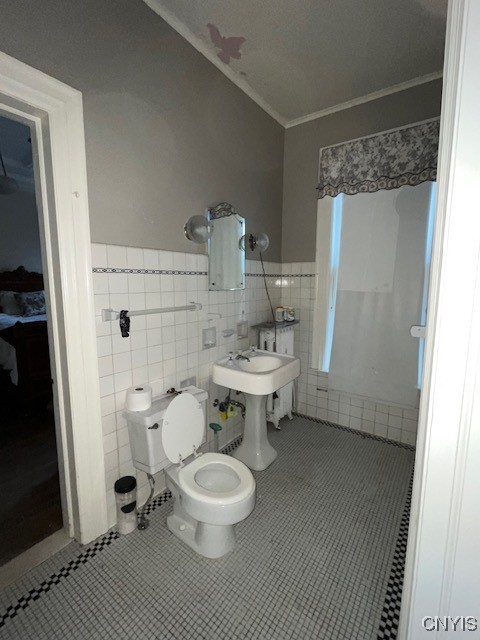 bathroom with ornamental molding, sink, tile walls, tile patterned flooring, and toilet