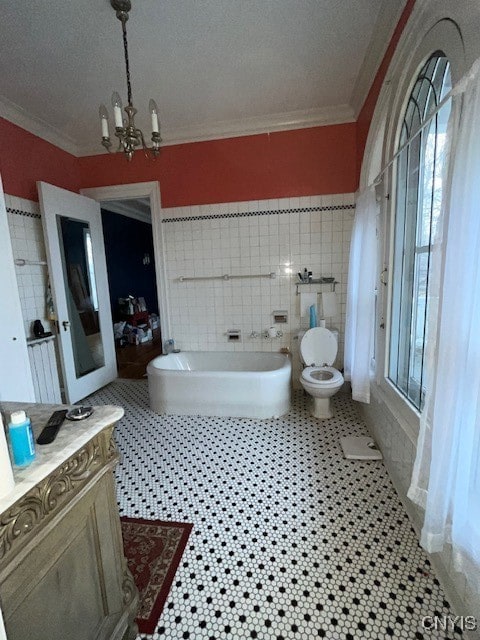 bathroom featuring tile patterned floors, toilet, tile walls, and an inviting chandelier