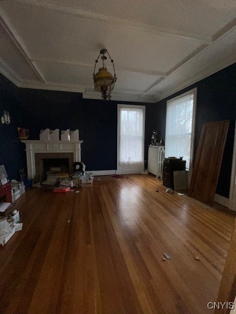 unfurnished living room featuring a textured ceiling and hardwood / wood-style flooring