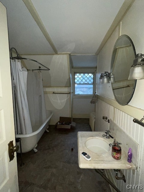 bathroom featuring shower / bath combination with curtain, concrete floors, and sink