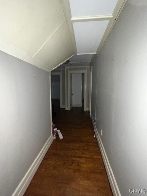 corridor featuring dark hardwood / wood-style floors and lofted ceiling