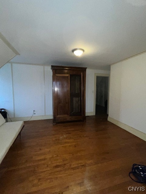 unfurnished living room with dark wood-type flooring