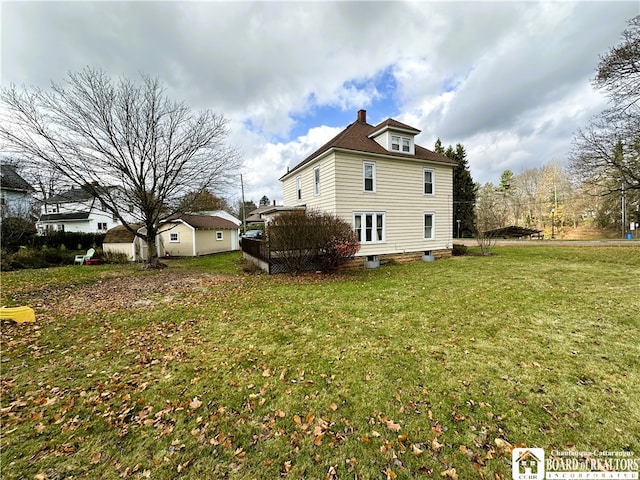 view of side of property with a lawn