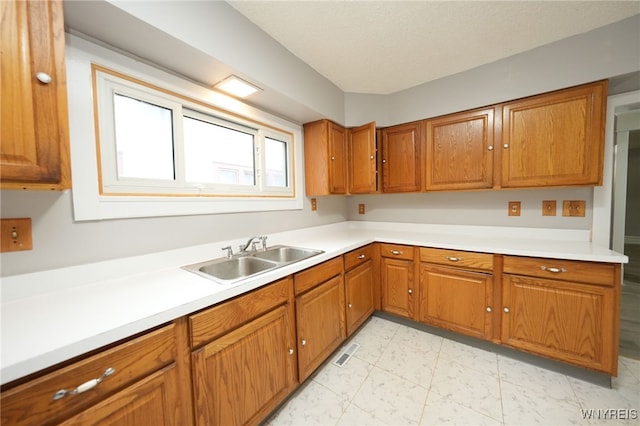 kitchen featuring sink and a textured ceiling