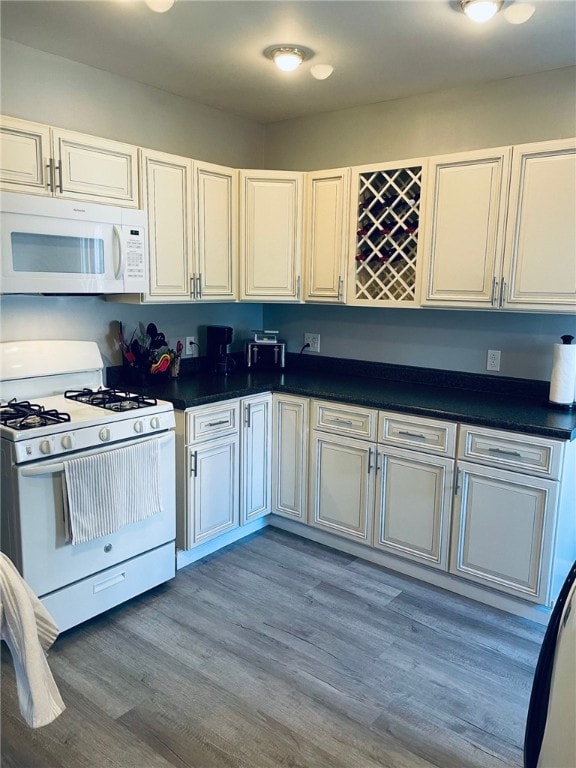 kitchen featuring white appliances and hardwood / wood-style flooring