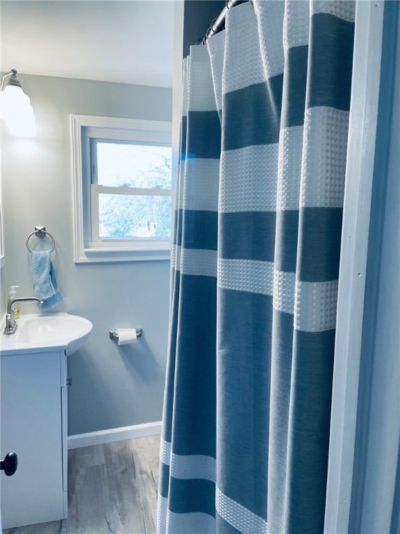 bathroom featuring hardwood / wood-style floors, vanity, and a shower with shower curtain