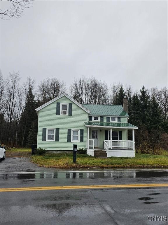 802 W End Ave, Wilna, NY 13619 - view of front of property featuring covered porch, a chimney, and metal roof