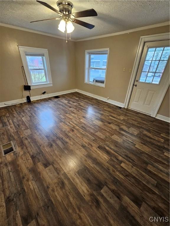 802 W End Ave, Wilna, NY 13619 - unfurnished living room with a textured ceiling, ornamental molding, plenty of natural light, dark wood-type flooring, and a ceiling fan
