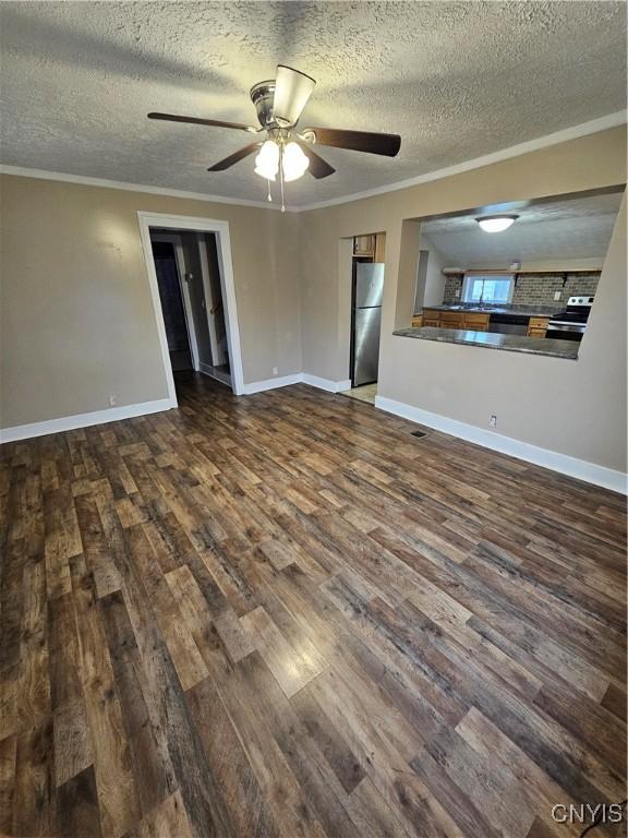 802 W End Ave, Wilna, NY 13619 - unfurnished living room featuring dark wood-style floors, a ceiling fan, crown molding, a textured ceiling, and baseboards